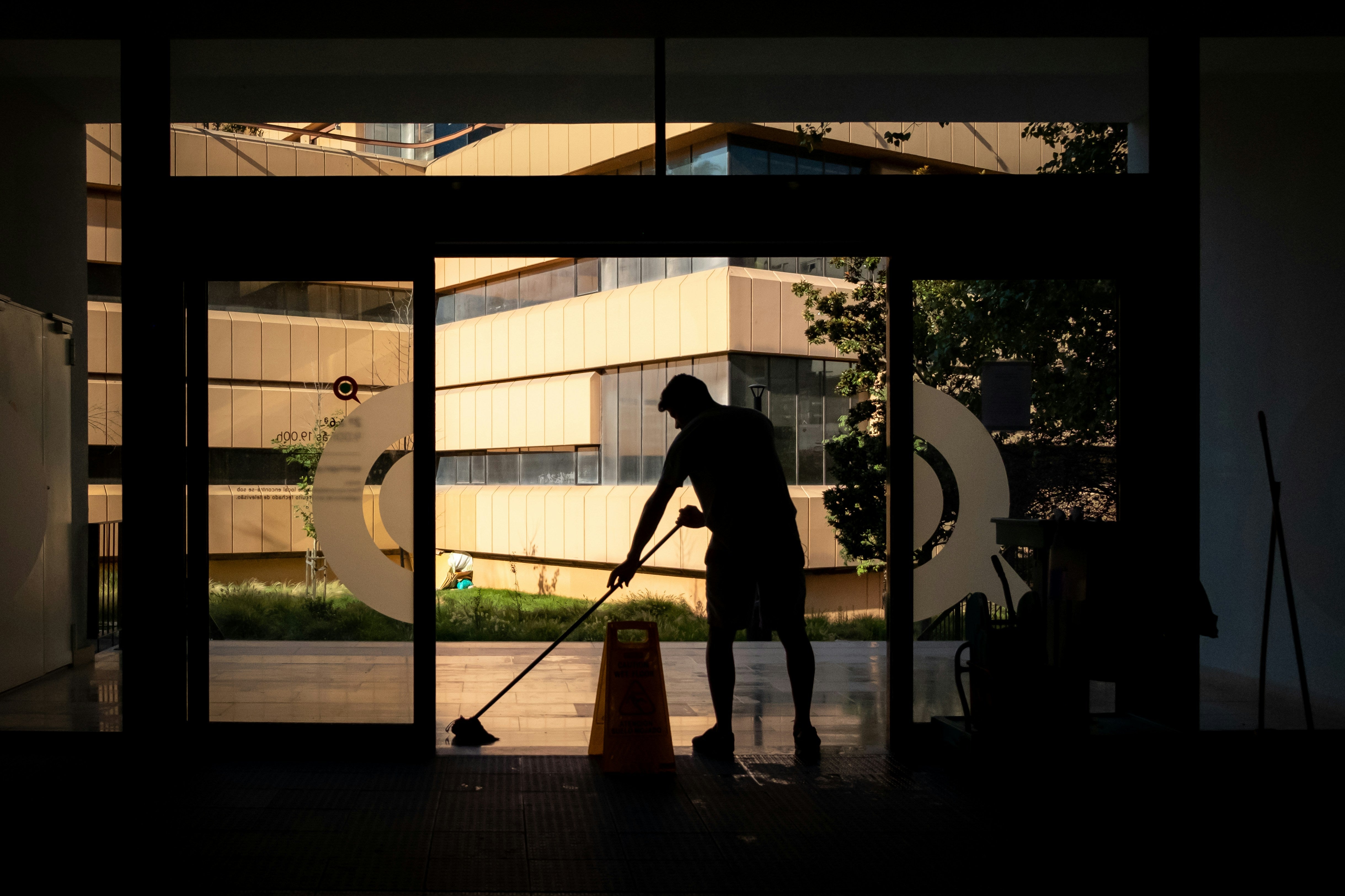 Cleaner mopping a commercial building floor - ShiningBright Cleaning services homes and offices in Duval, St. Johns, Clay, and Flagler Counties.